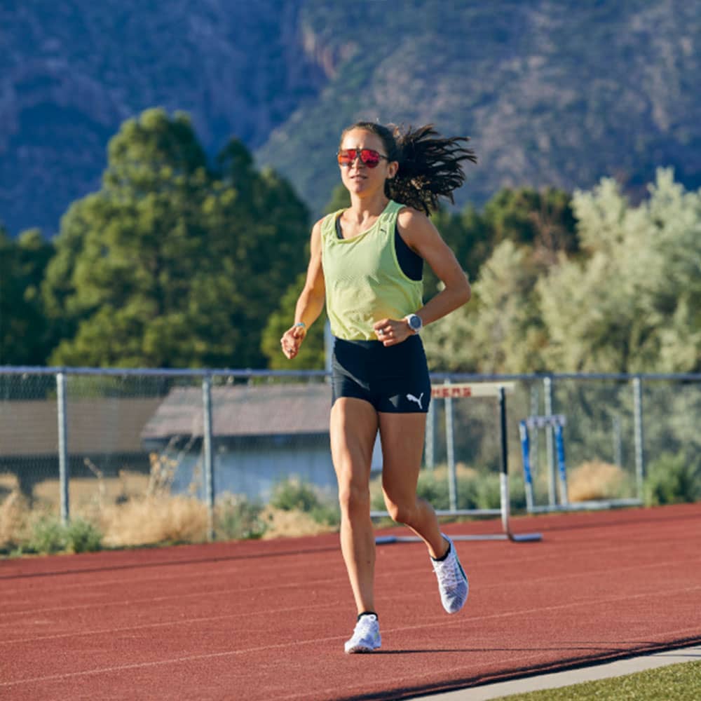 Une femme court sur une piste d'athlétisme